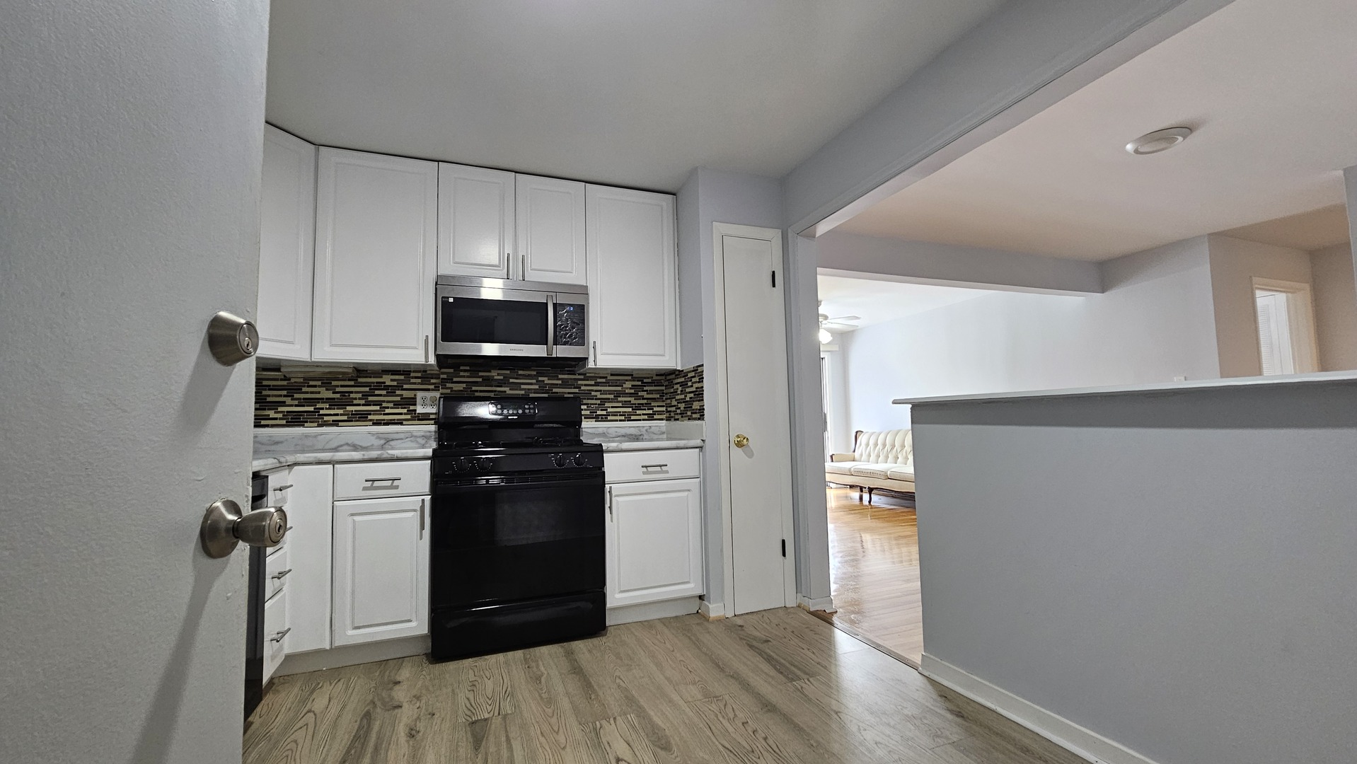 9588 Terrace Place, Unit 1C Des Plaines, IL 60016 - Photo 7 of 13 a kitchen with a refrigerator and a stove top oven