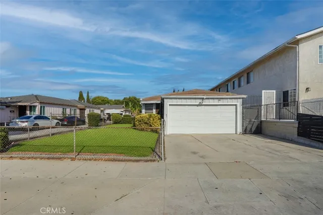 a view of a house with a yard and garage