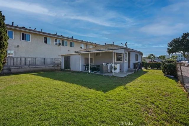 a view of a house with a backyard and a patio