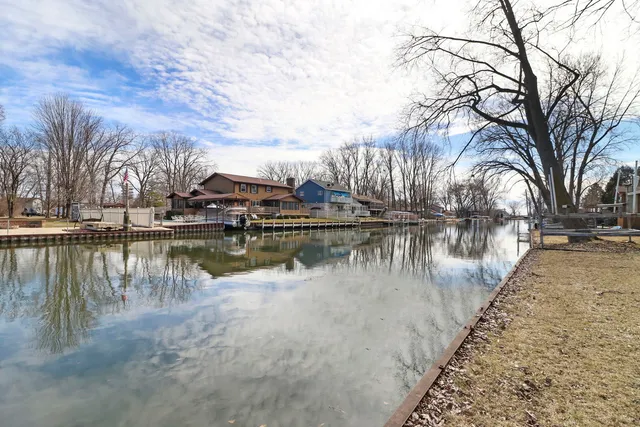 a view of river covered with snow in front of house