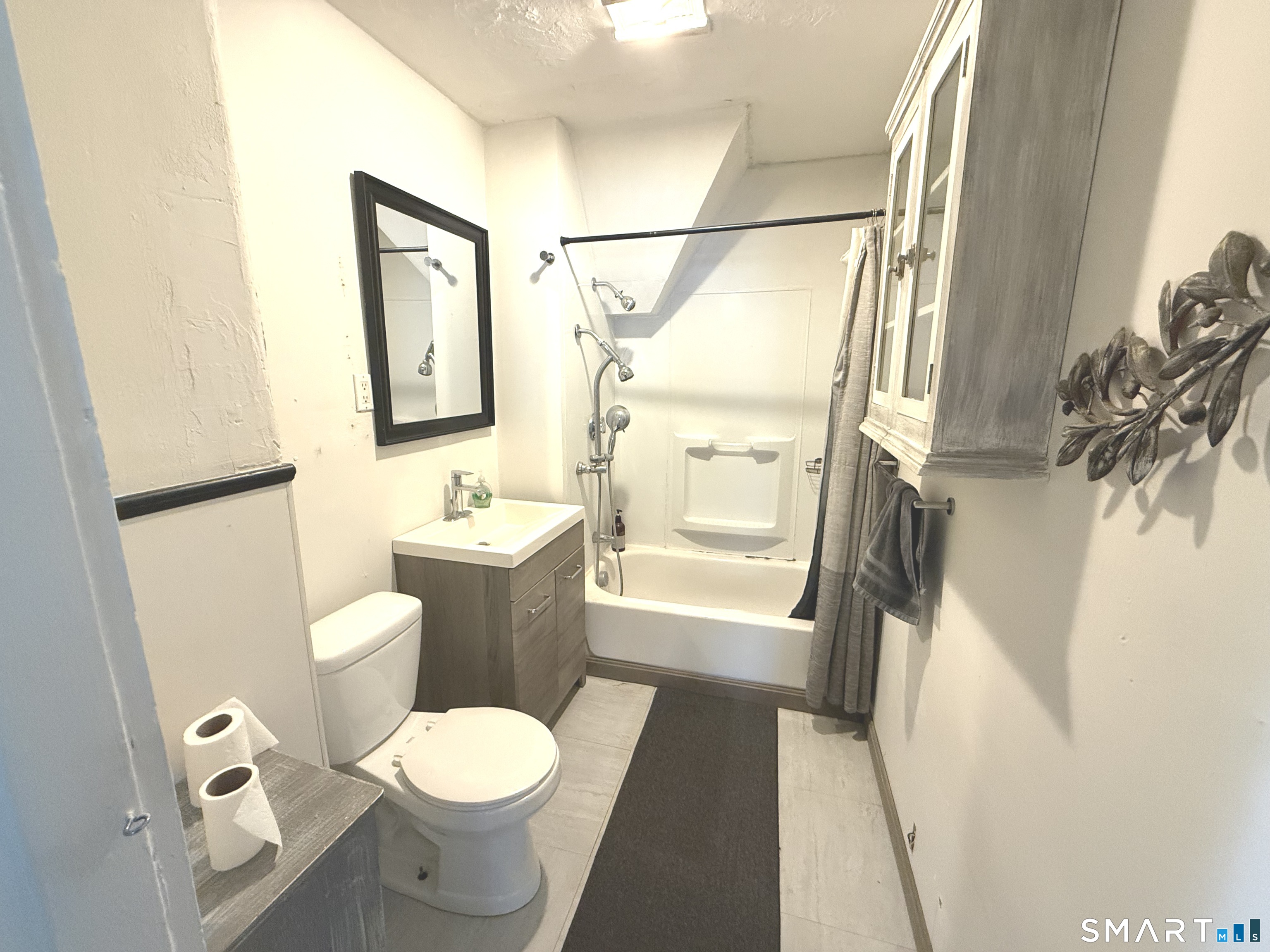 29 Florence Street Putnam, CT 06260 - Photo 8 of 17 a bathroom with a toilet sink and a mirror