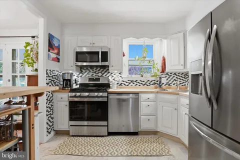 a kitchen with stainless steel appliances a refrigerator stove and sink