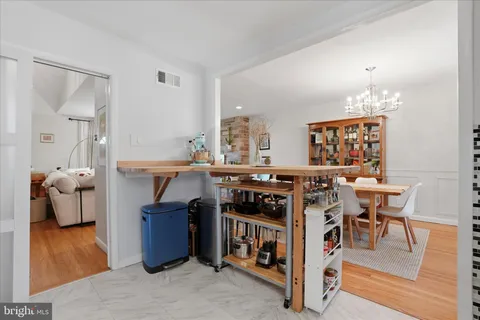 a kitchen with stainless steel appliances a stove a table and chairs