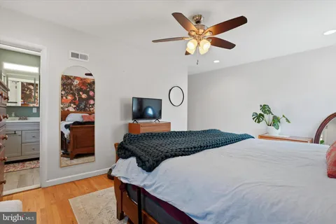 a bedroom with a bed and a television