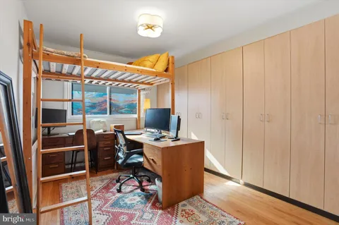 a view of a workspace with furniture and a window
