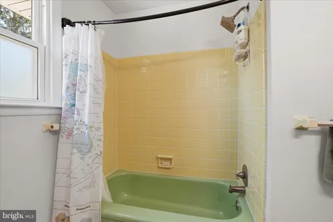 a bathroom with a shower and a tub