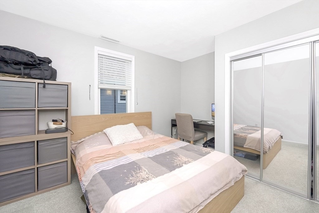 47-49 Botolph Street, Unit 49 Quincy, MA 02171 - Photo 12 of 14 a bedroom with a bed and wooden floor