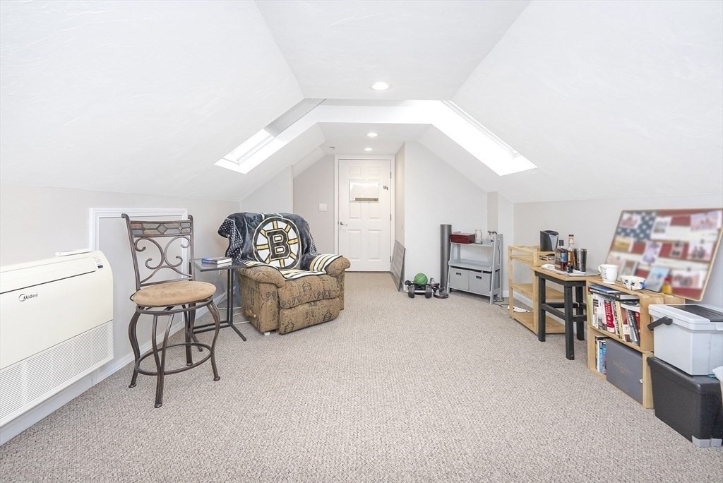 47-49 Botolph Street, Unit 49 Quincy, MA 02171 - Photo 13 of 14 a living room with furniture and a book shelf
