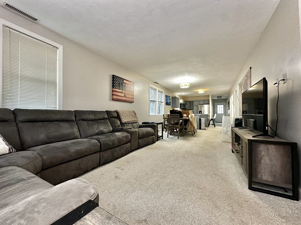 47-49 Botolph Street, Unit 49 Quincy, MA 02171 - Photo 2 of 14 a living room with furniture and a flat screen tv