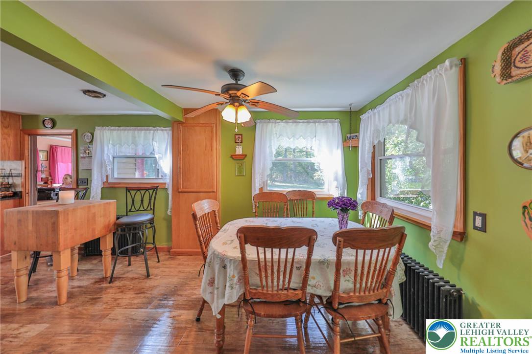 331 Cranberry Creek Road Cresco, PA 18326 - Photo 7 of 95 A quaint dining area bathed in natural light features a charming wooden table and overhead ceiling fan.