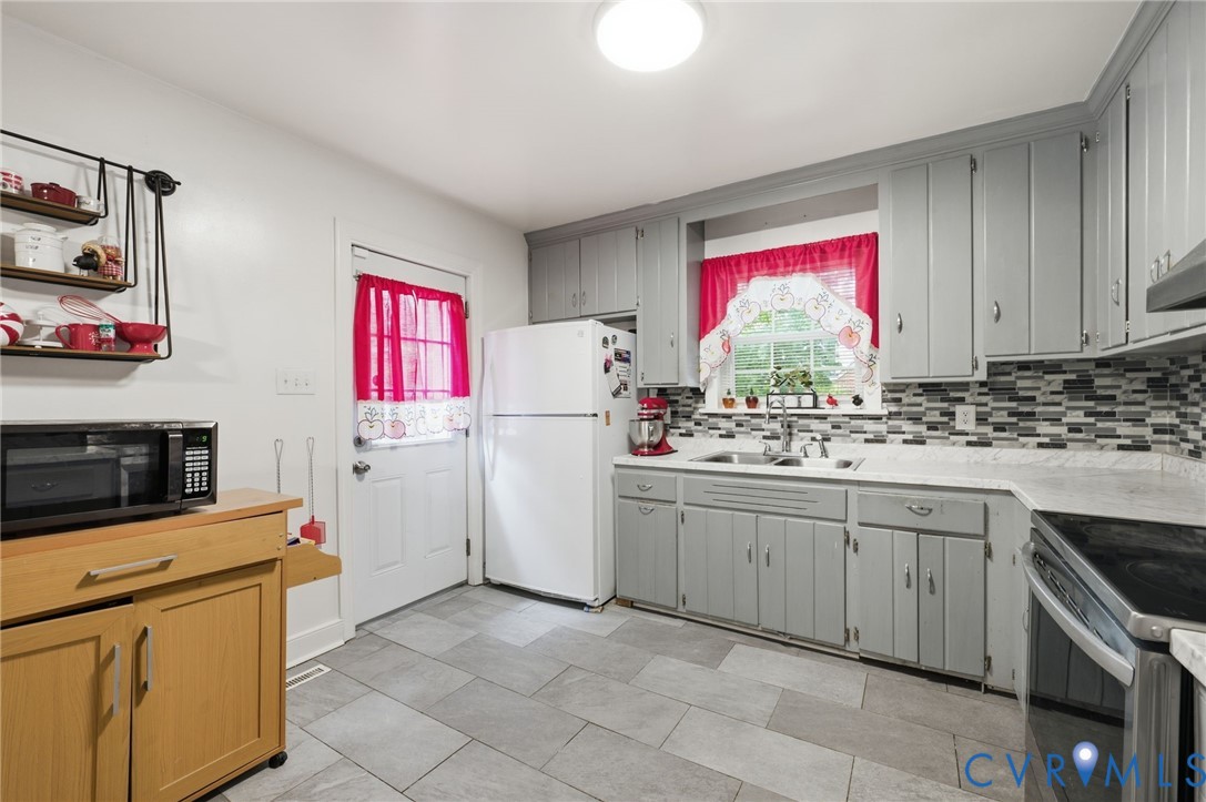 4021 Beulah Road Richmond, VA 23237 - Photo 11 of 27 Kitchen featuring gray shaker-style cabinetry, a m