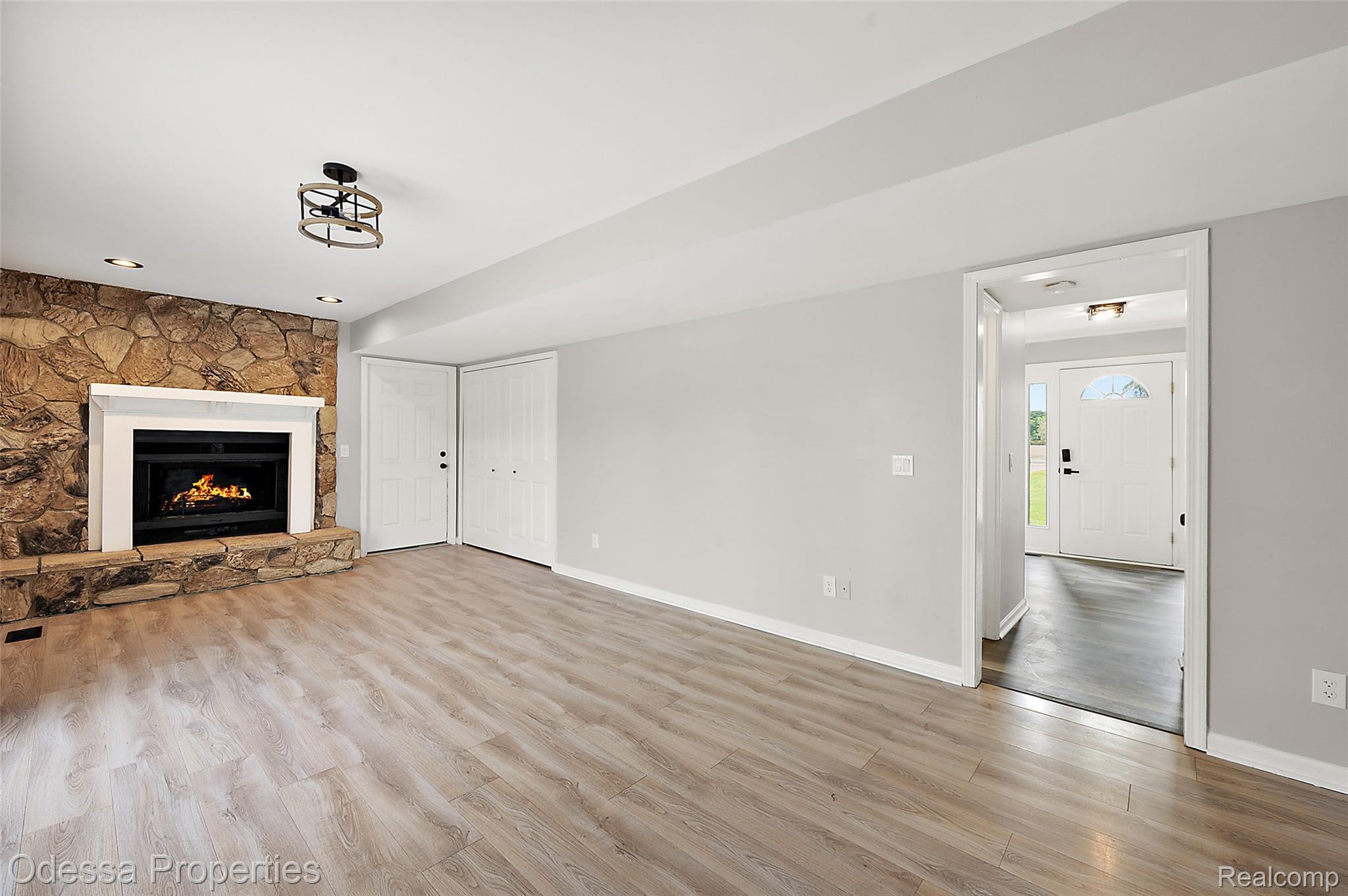 1442 Riley Center Road Memphis, MI 48041 - Photo 24 of 62 Unfurnished living room with light wood-style flooring and a fireplace