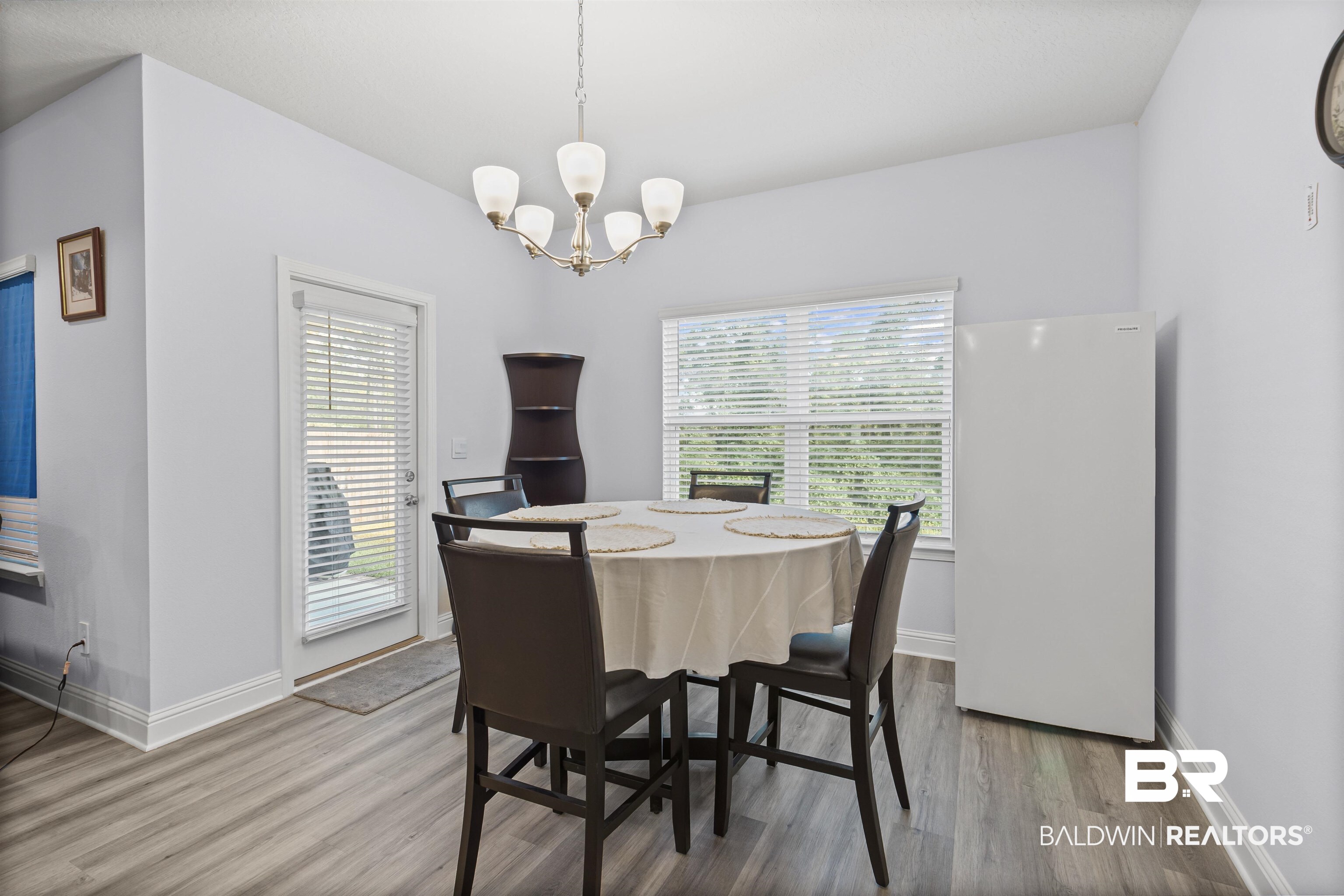 10564 Heirloom Road South Mobile, AL 36608 - Photo 11 of 24 Dining room featuring wood finished floors and a chandelier
