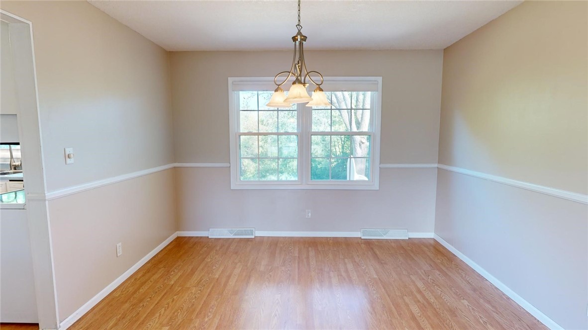 396 West Ash Avenue Decatur, IL 62526 - Photo 7 of 37 an empty room with wooden floor and windows