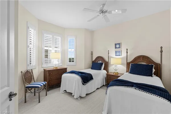 a bedroom with two beds and a couch