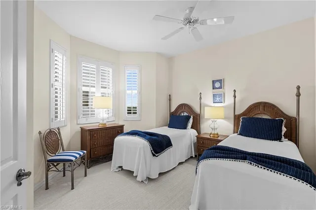 a bedroom with two beds and a couch