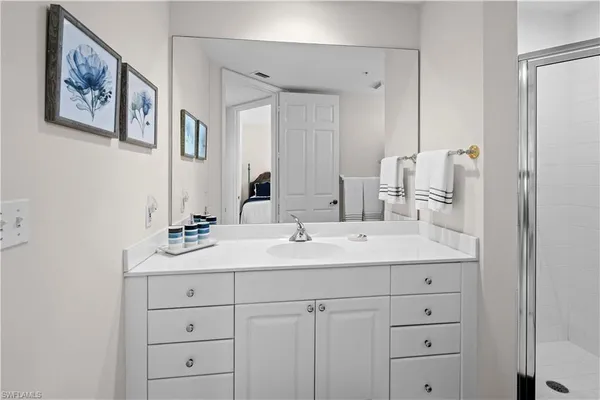 a bathroom with double sink and a mirror