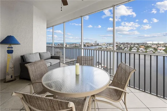 a dining room with furniture and a floor to ceiling window