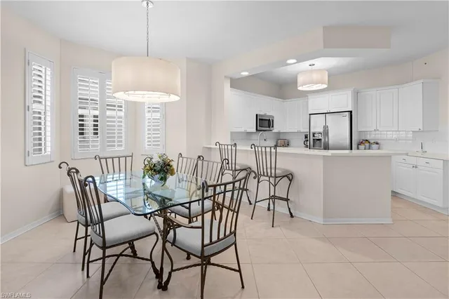 a view of a dining room with furniture and chandelier
