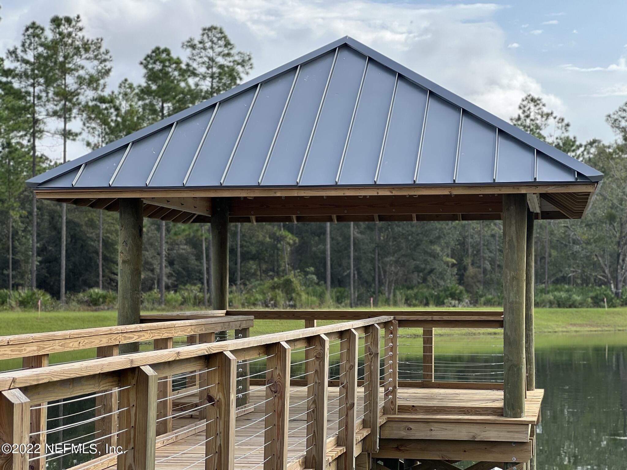 116 Fly Line Drive St. Johns, FL 32259 - Photo 49 of 51 a view of a wooden deck next to a yard