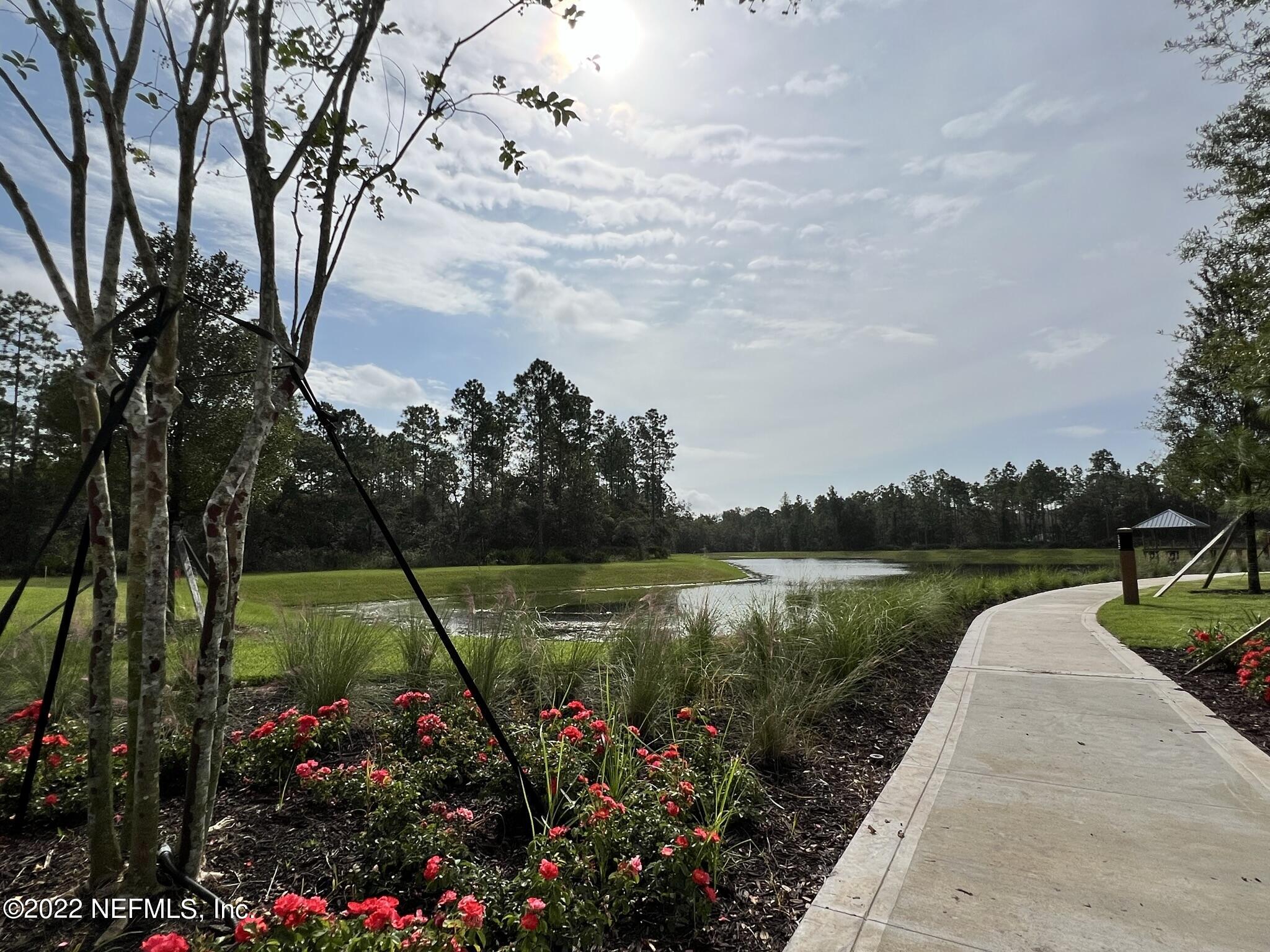 116 Fly Line Drive St. Johns, FL 32259 - Photo 50 of 51 a view of a garden with flowers and buildings in the background