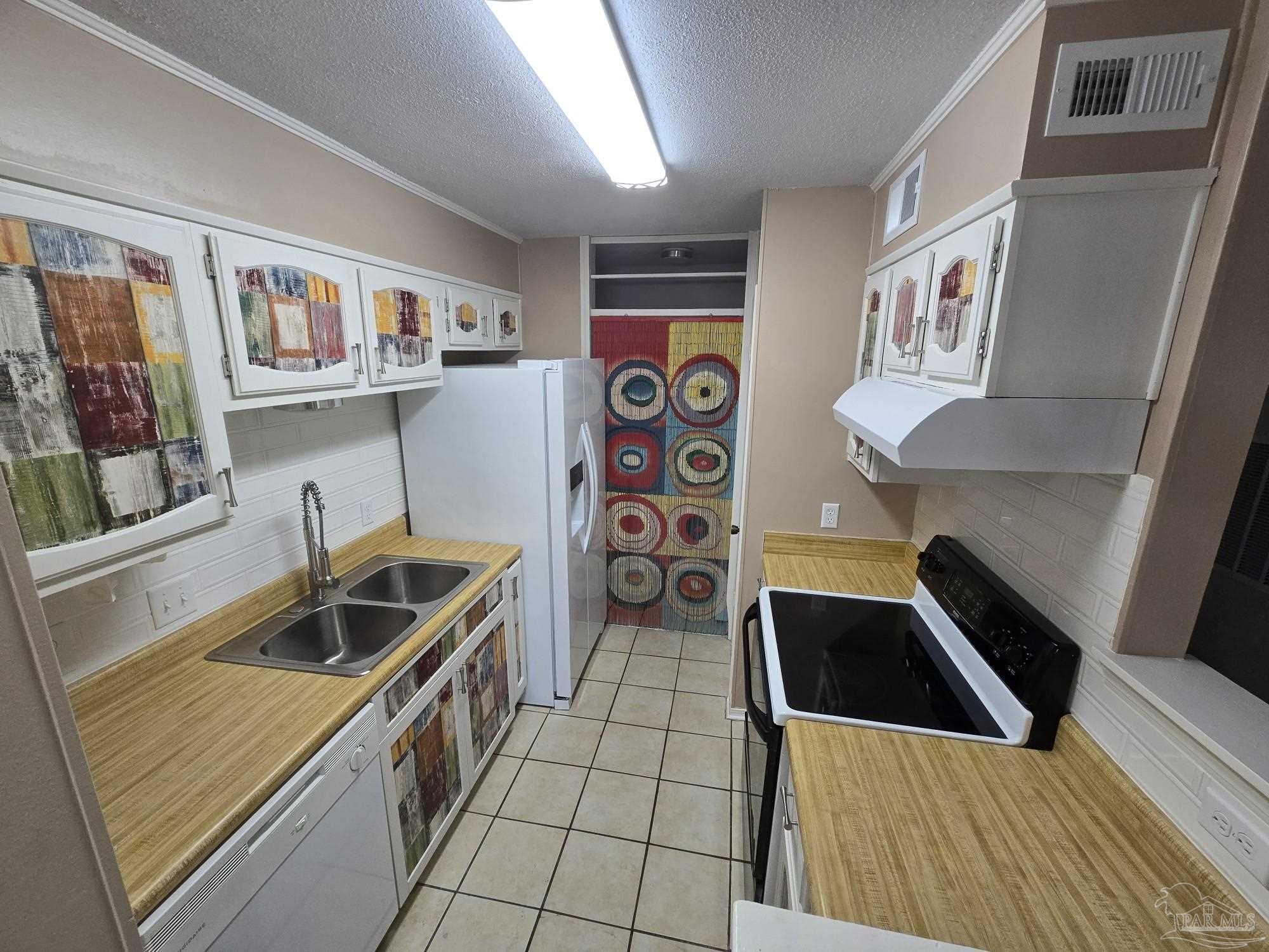 2303 West Michigan Avenue, Unit B10 Pensacola, FL 32526 - Photo 1 of 25 a kitchen with stainless steel appliances a stove a sink and a refrigerator