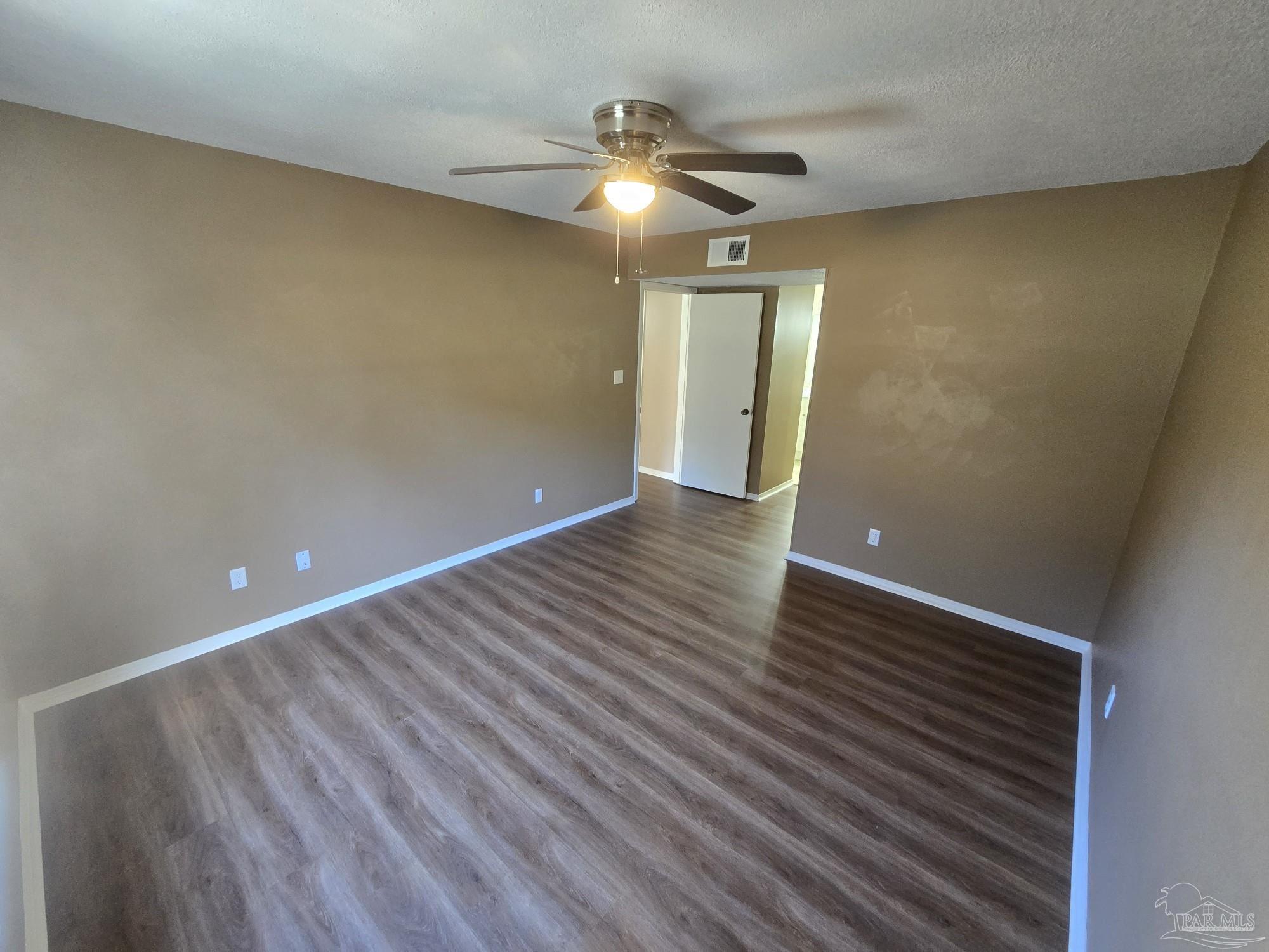 2303 West Michigan Avenue, Unit B10 Pensacola, FL 32526 - Photo 11 of 25 wooden floor in an empty room with a window