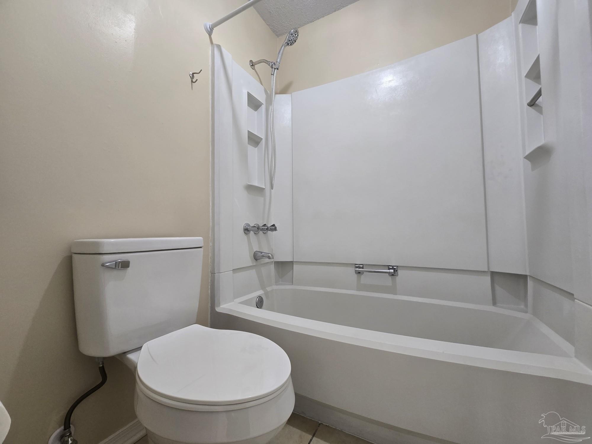 2303 West Michigan Avenue, Unit B10 Pensacola, FL 32526 - Photo 13 of 25 a white toilet sitting next to a bath tub