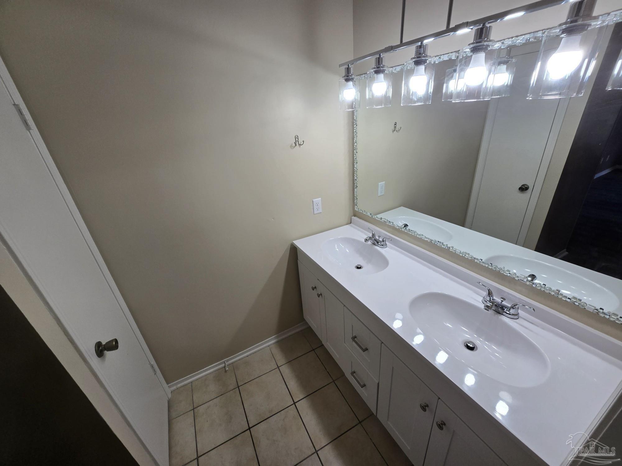 2303 West Michigan Avenue, Unit B10 Pensacola, FL 32526 - Photo 14 of 25 a bathroom with a double vanity sink and mirror