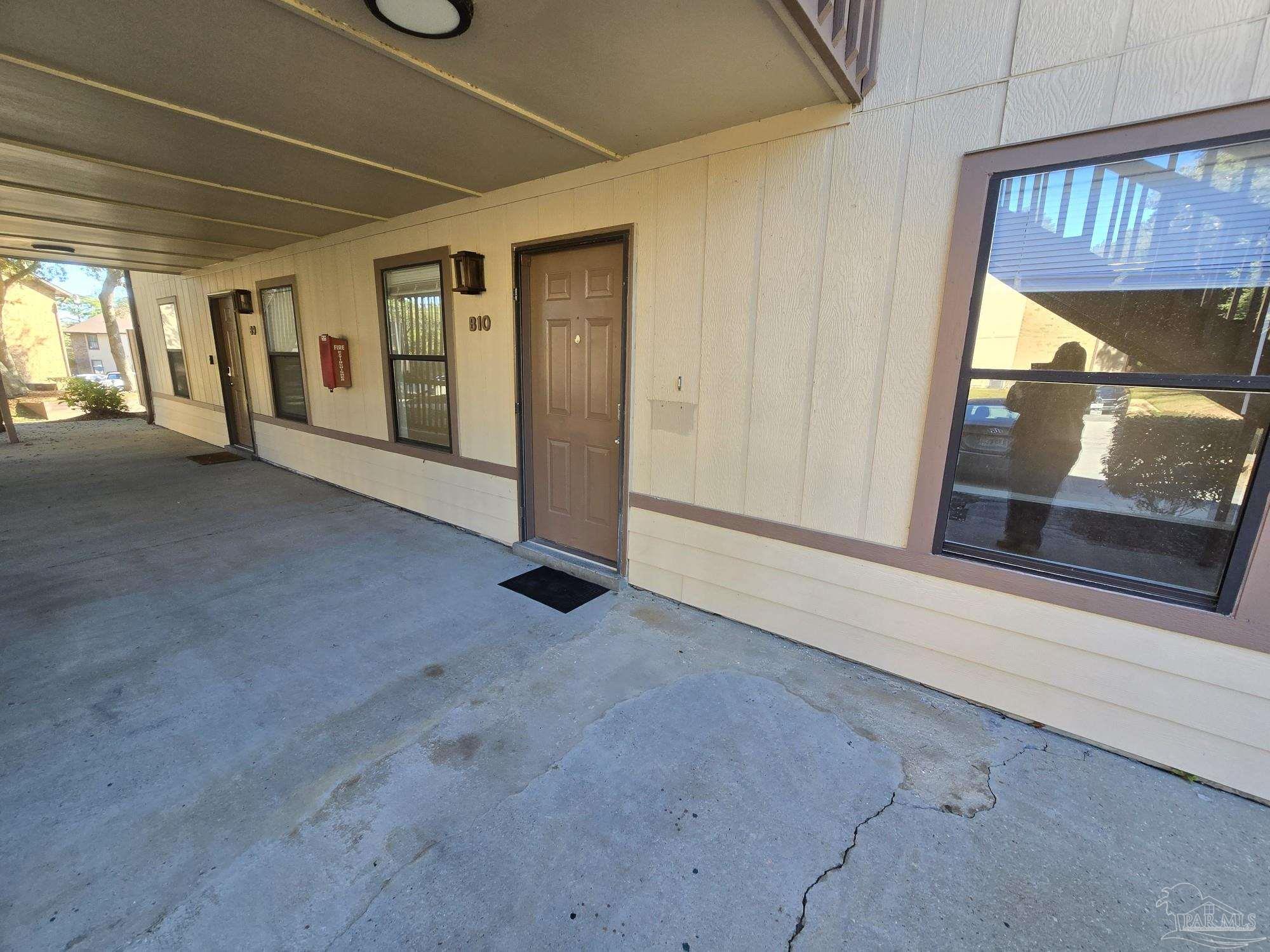 2303 West Michigan Avenue, Unit B10 Pensacola, FL 32526 - Photo 17 of 25 a view of a room with wooden floor and windows