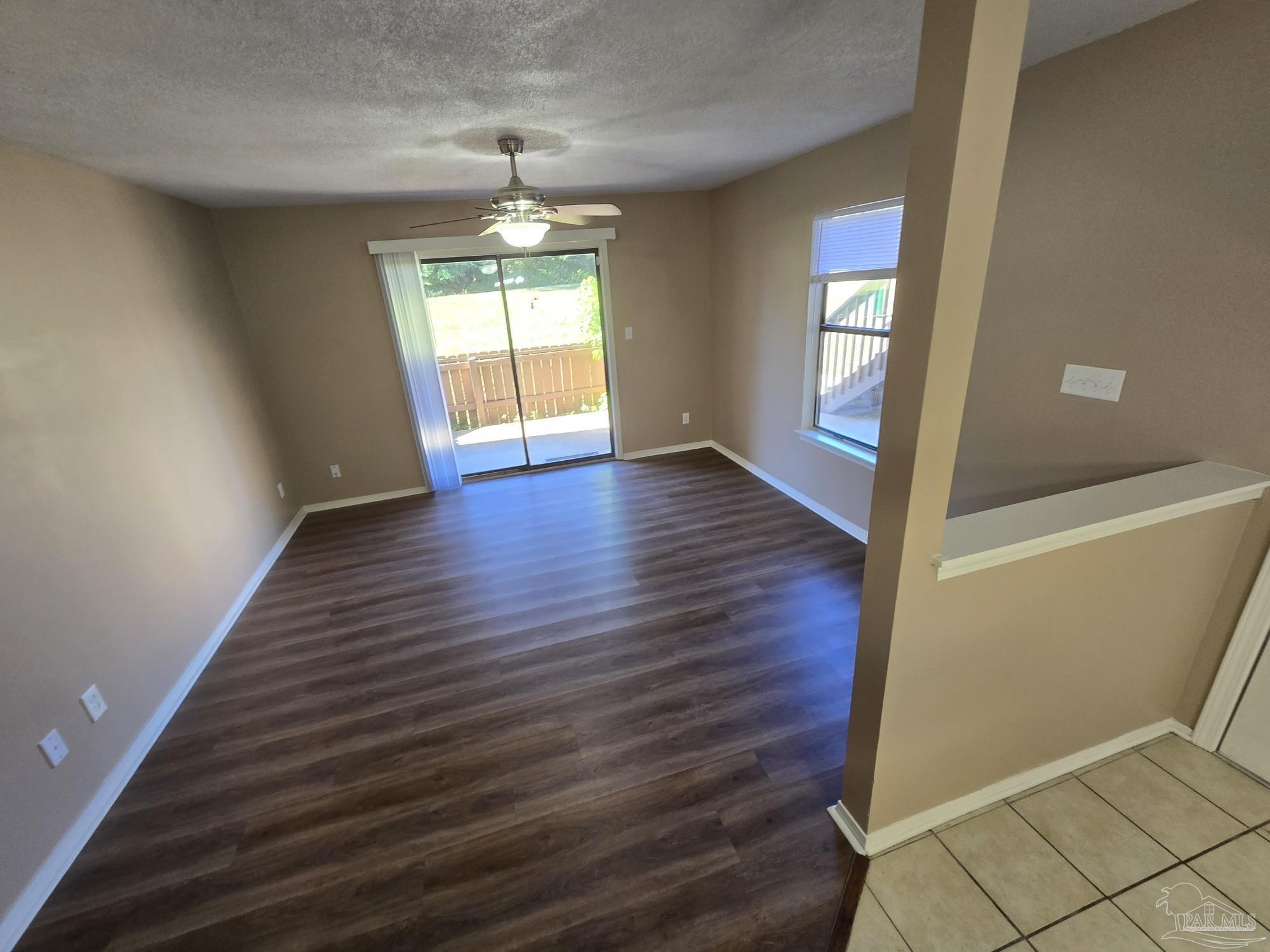 2303 West Michigan Avenue, Unit B10 Pensacola, FL 32526 - Photo 5 of 25 a view of an empty room with wooden floor and a window