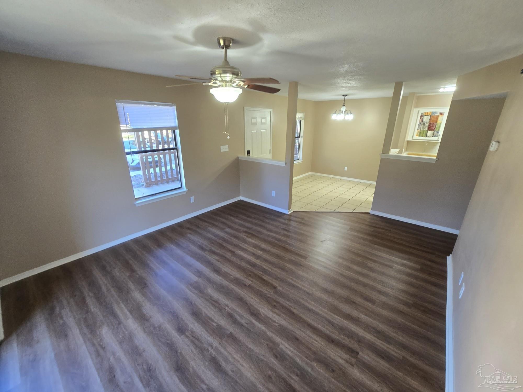 2303 West Michigan Avenue, Unit B10 Pensacola, FL 32526 - Photo 6 of 25 a view of an empty room with wooden floor and a window