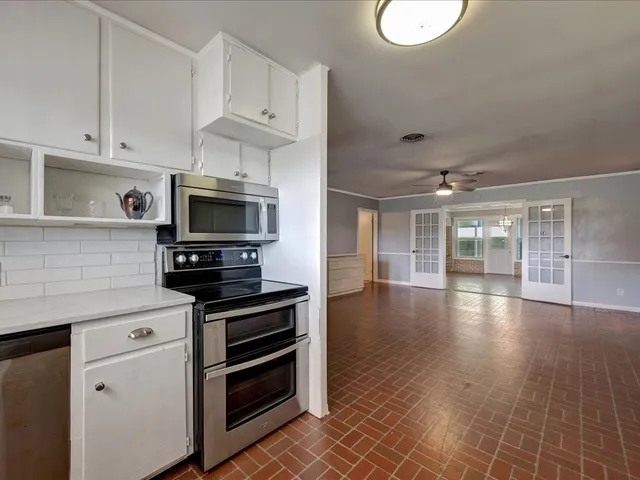 a kitchen with granite countertop a stove and a sink