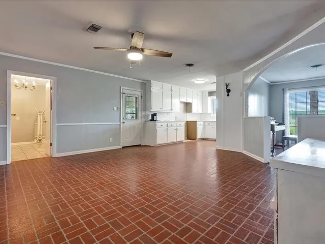 a view of a kitchen with a sink and cabinets