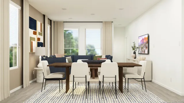 a view of a dining room with furniture a rug and wooden floor