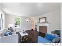 78 Main Street Tappan, NY 10983 - Photo 13 of 25 a living room with furniture a fireplace and a large window