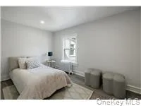 a bedroom with a bed and a night stand