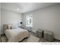 78 Main Street Tappan, NY 10983 - Photo 15 of 25 a bedroom with a bed and a night stand