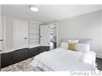 78 Main Street Tappan, NY 10983 - Photo 20 of 25 a bedroom with a bed and a night stand