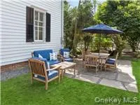 a view of backyard with outdoor seating and green space
