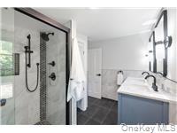 78 Main Street Tappan, NY 10983 - Photo 10 of 25 a bathroom with a sink mirror and shower