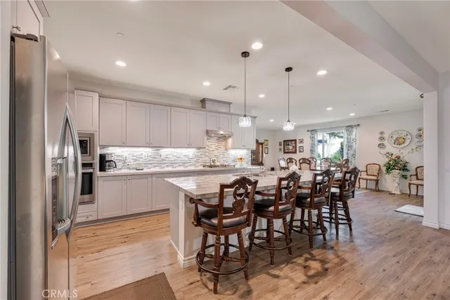 a kitchen with stainless steel appliances granite countertop white cabinets a sink and dishwasher