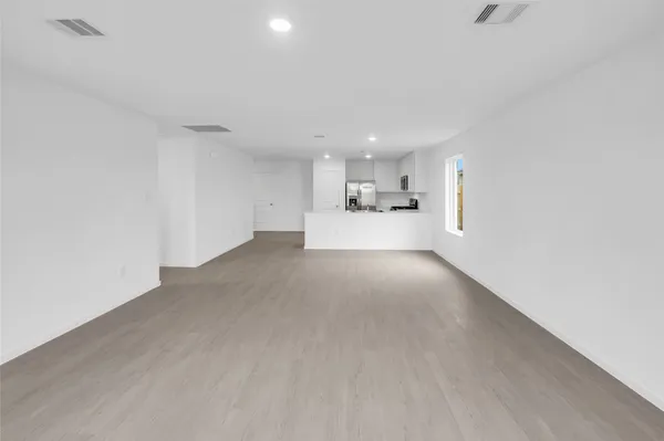 a kitchen with kitchen island a refrigerator sink microwave and cabinets