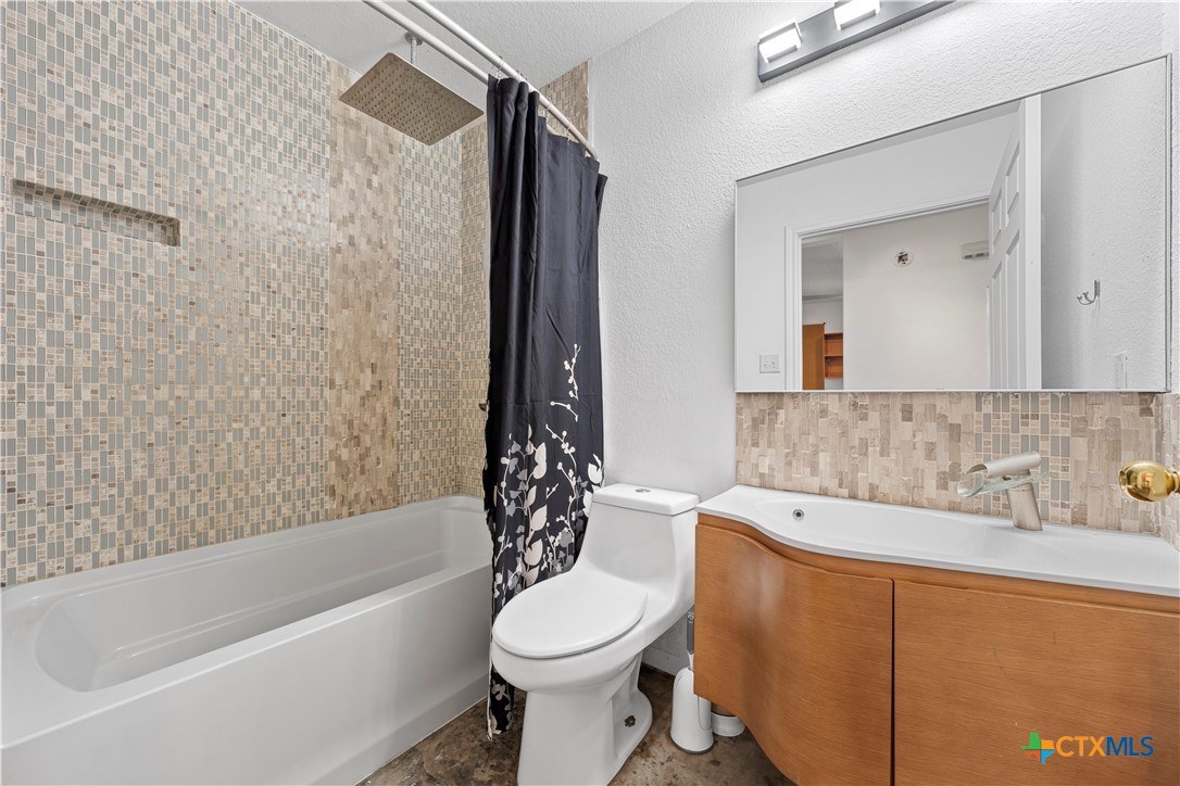 1101 East Walnut Street Waco, TX 76704 - Photo 16 of 17 a bathroom with a sink toilet and shower