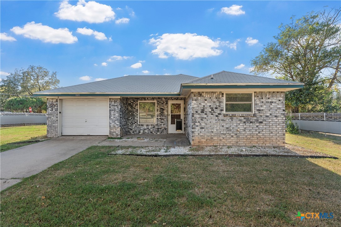 1101 East Walnut Street Waco, TX 76704 - Photo 2 of 17 a front view of a house with a garden and yard