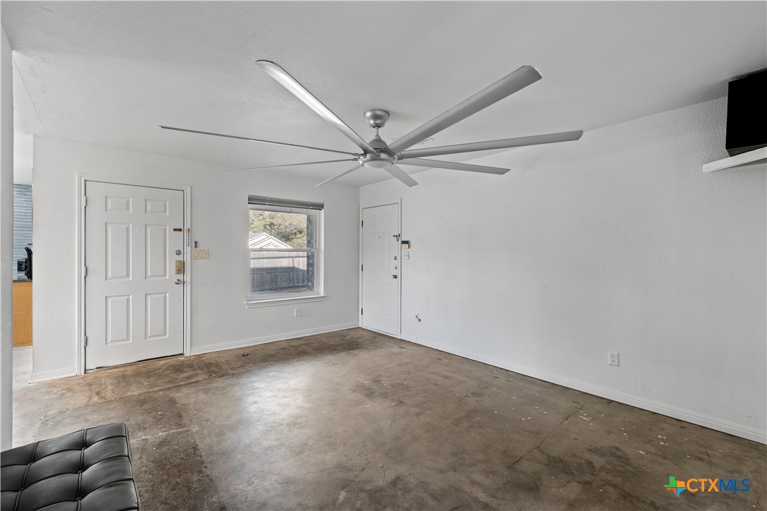 1101 East Walnut Street Waco, TX 76704 - Photo 6 of 17 an empty room with windows and ceiling fan