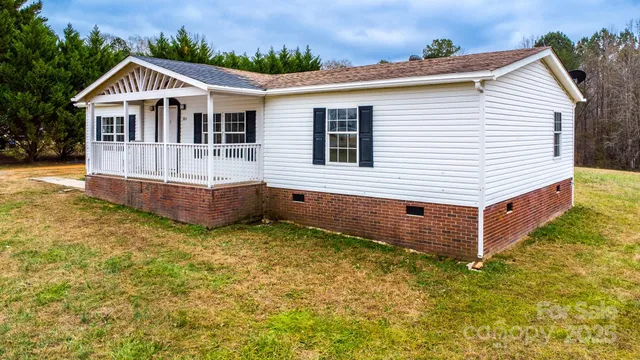 a view of a house with a yard and sitting area