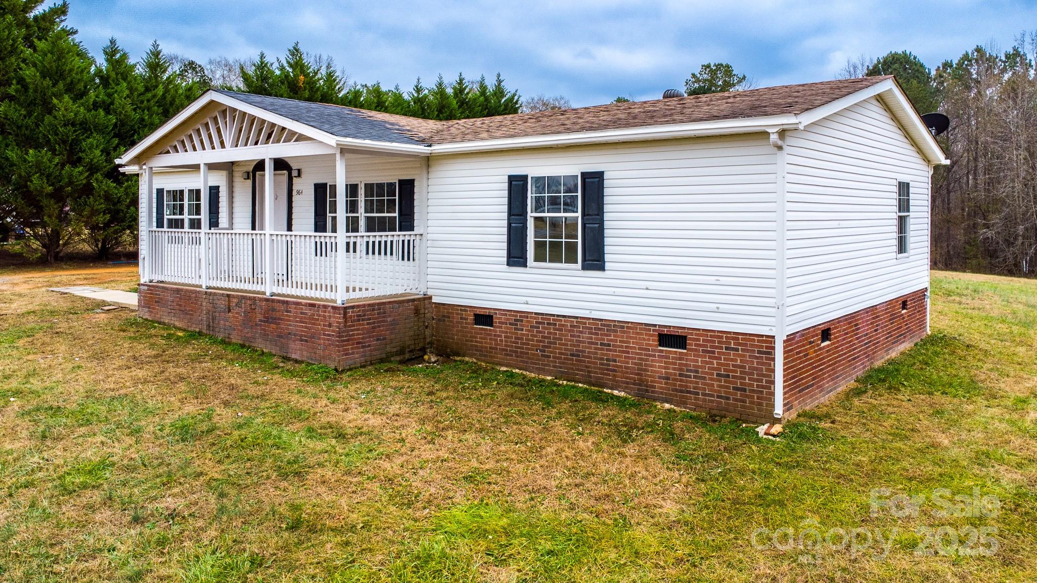 a view of a house with a yard and sitting area