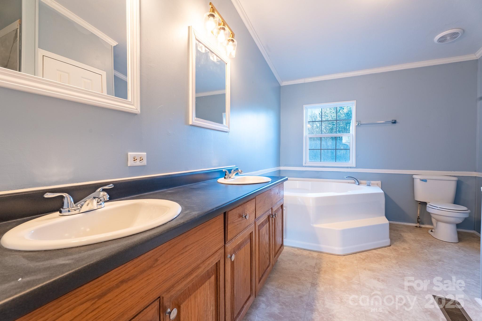 964 Lavender Road Grover, NC 28073 - Photo 12 of 26 a bathroom with a granite countertop sink and a bathtub