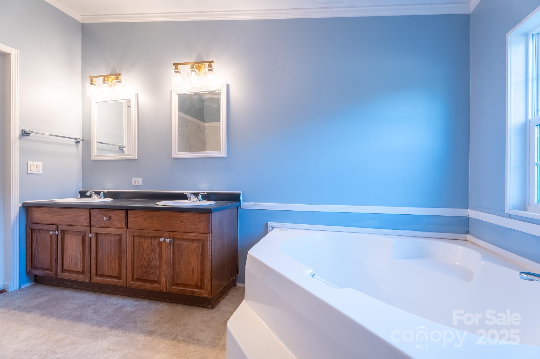 964 Lavender Road Grover, NC 28073 - Photo 13 of 26 a bathroom with a bathtub a mirror a sink and vanity